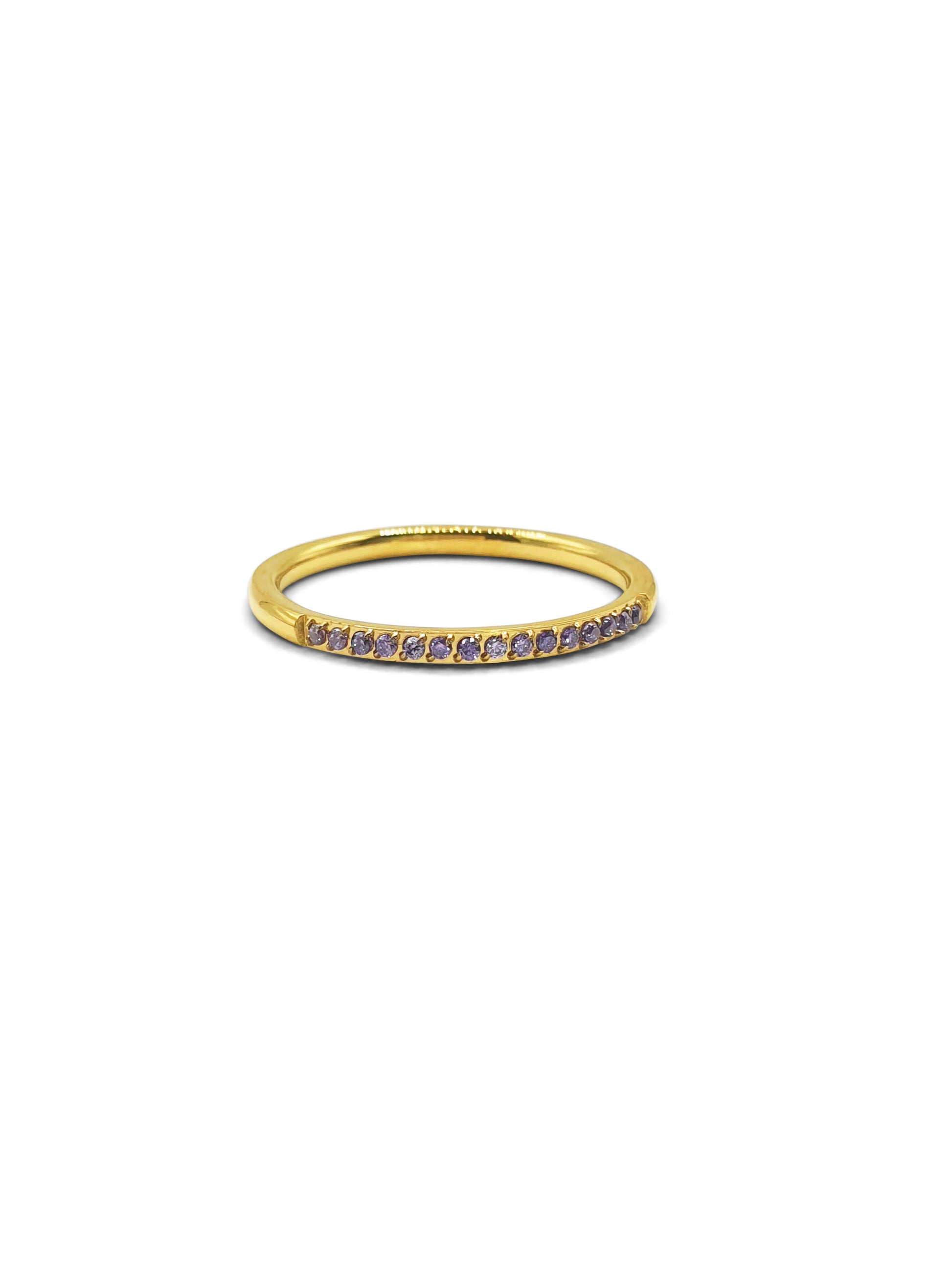 A gold stackable band ring set at the top with small purple gems