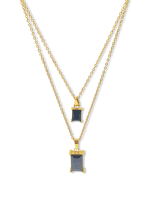 A gold double layered necklace with black rectangle jewel pendants