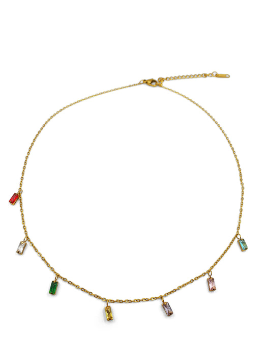 A dainty gold necklace with dangling gems in multiple colours