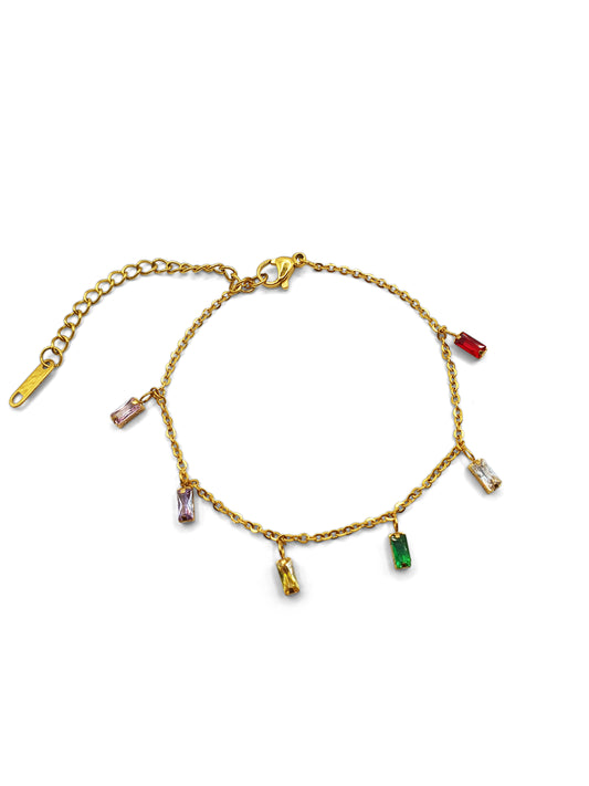 A dainty gold bracelet with dangling gems in multiple colours